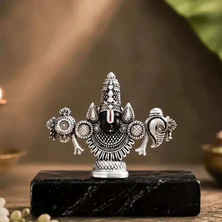 Silver plated Lord Balaji face idol on a black stand
